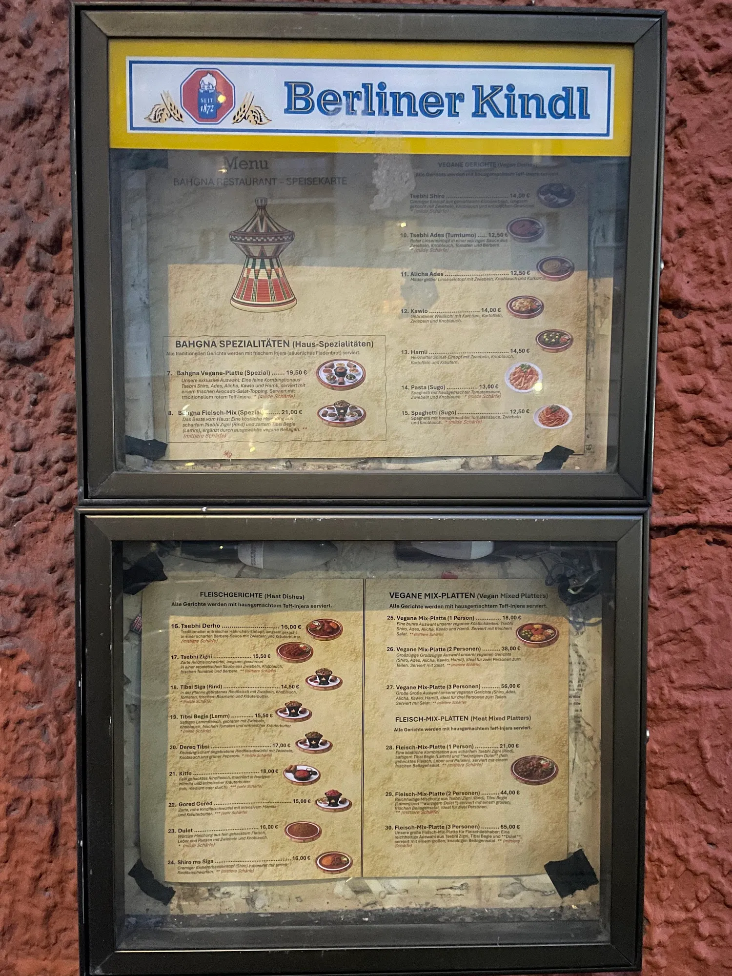 Die Speisekarte von Bahgna auf einer Tafel vor dem Restaurant, mit den Kapiteln Spezialitäten, Fleischgerichte und Mix-Platten